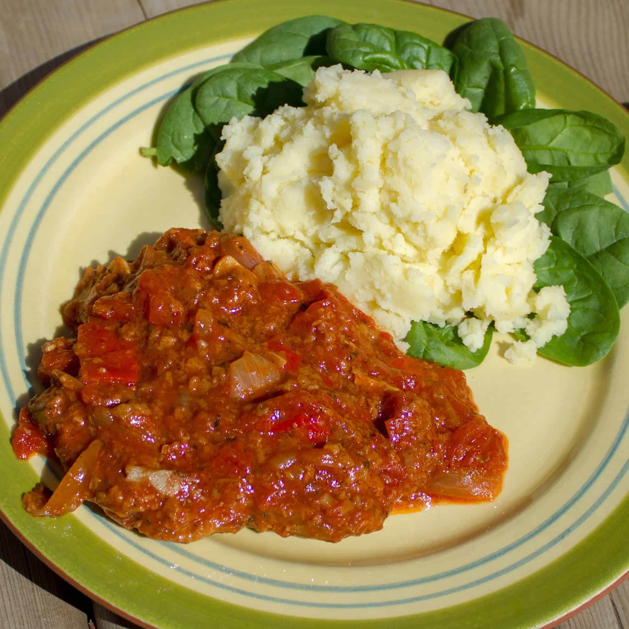 Swiss steak takes a cheap and tough cut of beef like round or sirloin steak (cube or minute), which is then braised in stewed tomatoes and other vegetables.