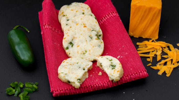 Minced jalapeno pepper and grated cheddar cheese are mixed with shortbread cookie dough to create this savory cookie recipe. These icebox cookies are chilled, cut and then baked.