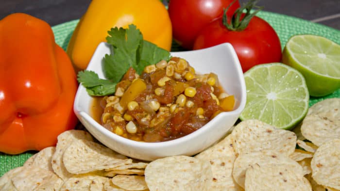 A fresh salsa with tomatoes, corn, onions, sweet peppers, jalapeno peppers, cumin and cilantro. A great Mexican appetizer to go with nacho tortilla chips.