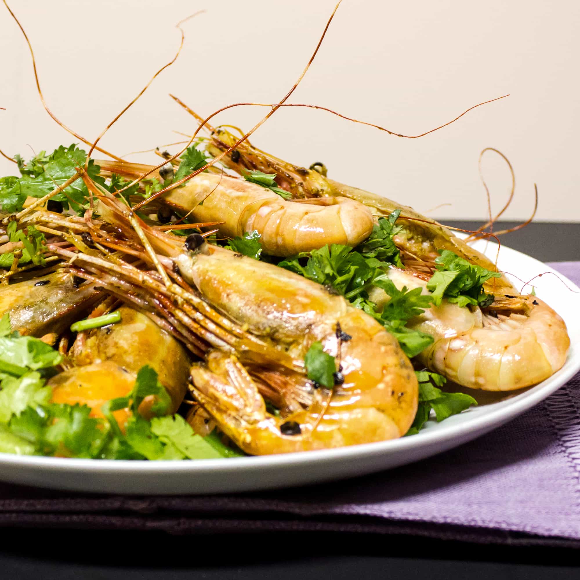 Easy to prepare king prawns cooked in a skillet with Thai chilies, garlic and oil with a cilantro garnish. Australian and Asian seafood similar to shrimp.