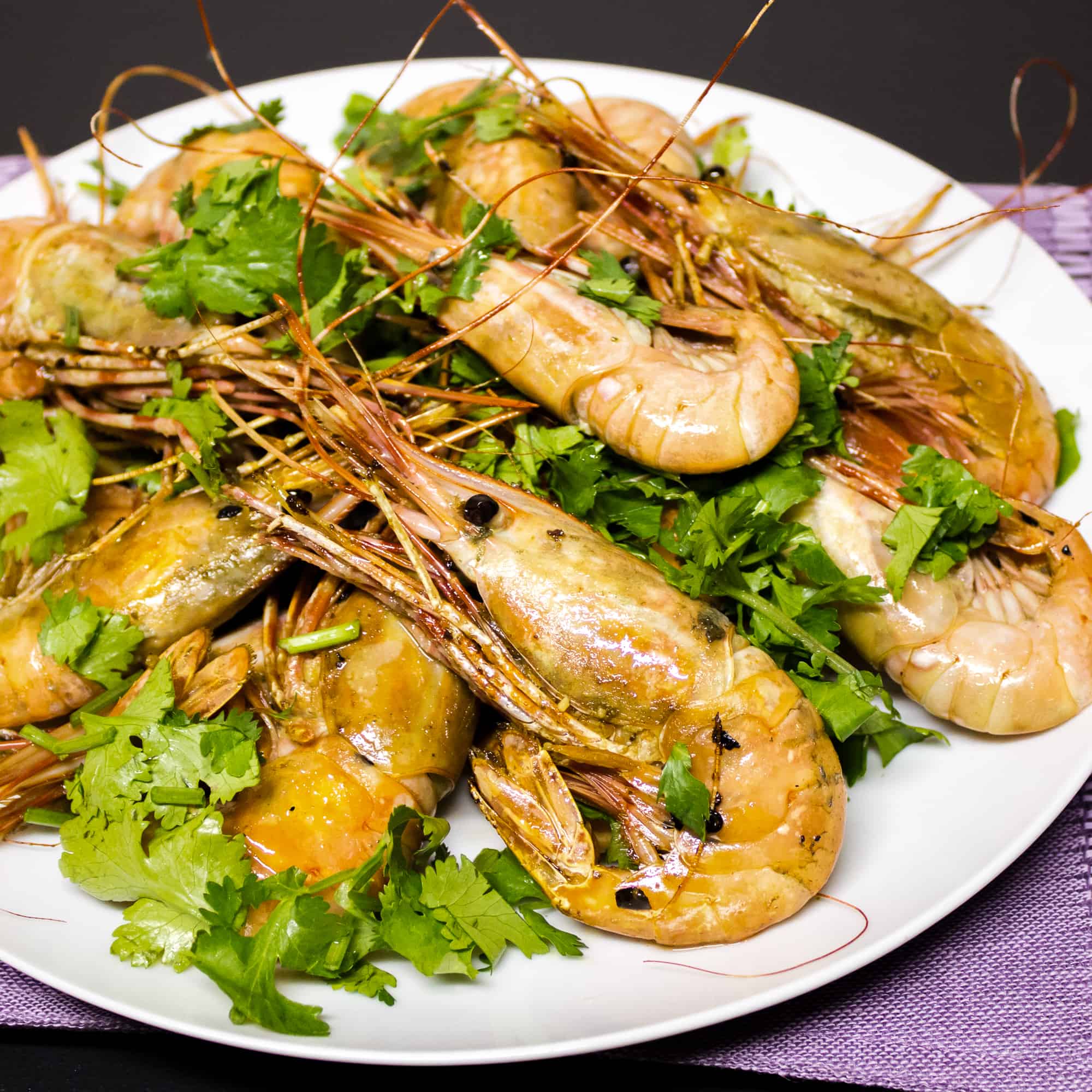 Easy to prepare king prawns cooked in a skillet with Thai chilies, garlic and oil with a cilantro garnish. Australian and Asian seafood similar to shrimp.