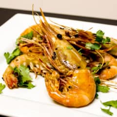 Easy to prepare king prawns cooked in a skillet with Thai chilies, garlic and oil with a cilantro garnish. Australian and Asian seafood similar to shrimp.