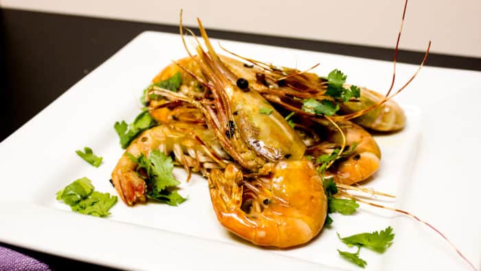 Easy to prepare king prawns cooked in a skillet with Thai chilies, garlic and oil with a cilantro garnish. Australian and Asian seafood similar to shrimp.