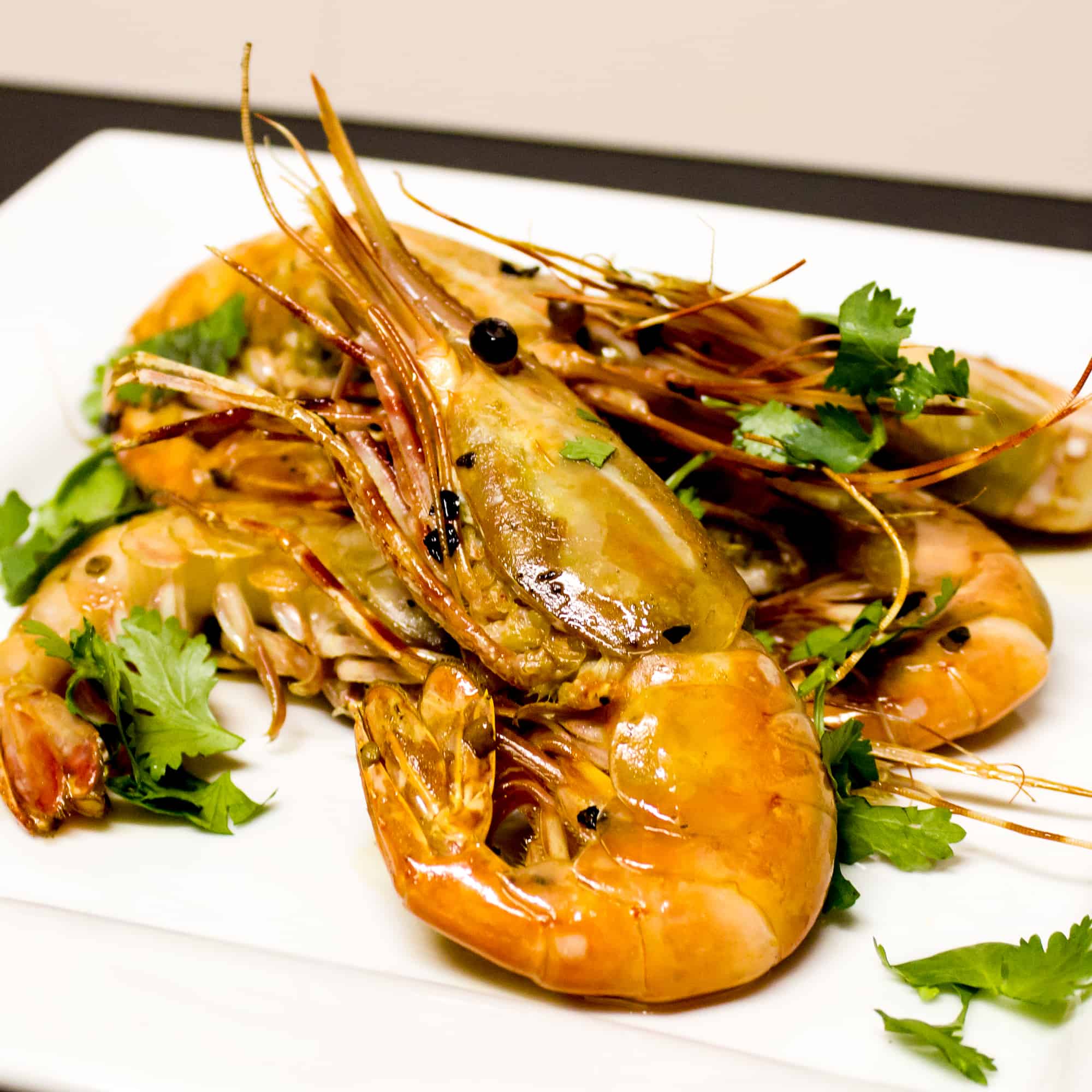 Easy to prepare king prawns cooked in a skillet with Thai chilies, garlic and oil with a cilantro garnish. Australian and Asian seafood similar to shrimp.