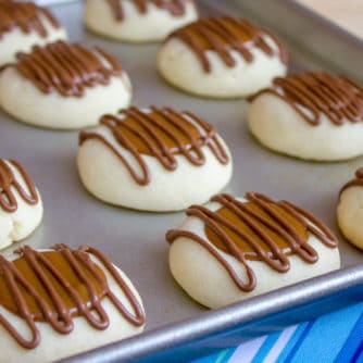 A recipe for a shortbread thumbprint cookie filled with dulce de leche and drizzled with melted chocolate. Tastes similar to a Twix candy bar with the caramel and chocolate.