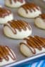 A recipe for a shortbread thumbprint cookie filled with dulce de leche and drizzled with melted chocolate. Tastes similar to a Twix candy bar with the caramel and chocolate.