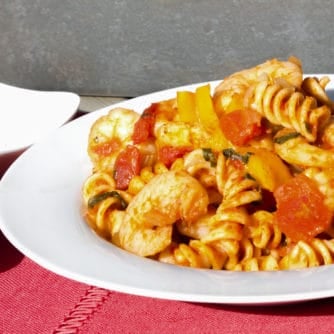 Shrimp pomodoro with rotini pasta. Easy Italian tomato based marinara sauce with white wine, peppers, onions, celery and garlic with tender shrimp as the seafood.