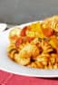 Shrimp pomodoro with rotini pasta. Easy Italian tomato based marinara sauce with white wine, peppers, onions, celery and garlic with tender shrimp as the seafood.