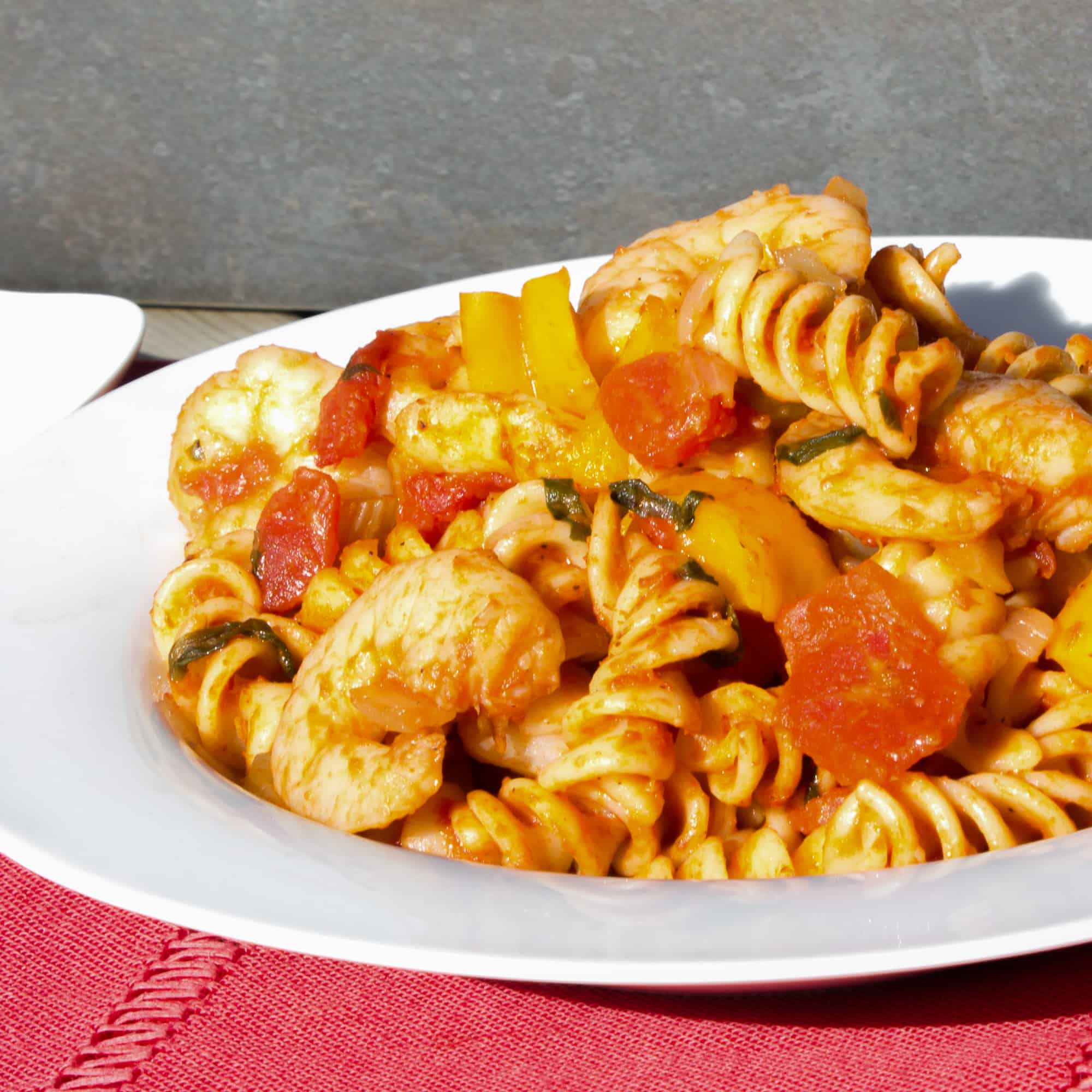 Shrimp pomodoro with rotini pasta. Easy Italian tomato based marinara sauce with white wine, peppers, onions, celery and garlic with tender shrimp as the seafood.