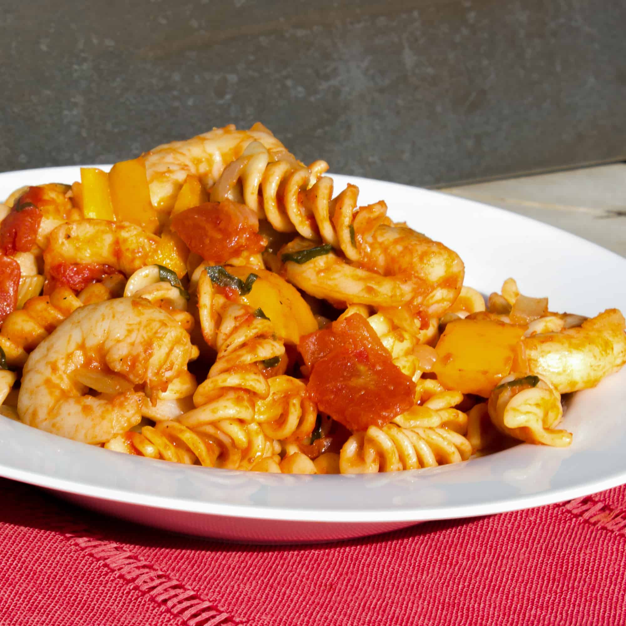 Shrimp pomodoro with rotini pasta. Easy Italian tomato based marinara sauce with white wine, peppers, onions, celery and garlic with tender shrimp as the seafood.