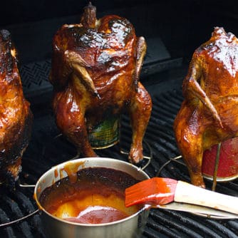 Classic beer can chicken done on the grill. Easy recipe for BBQ chicken. with a rub and sauce
