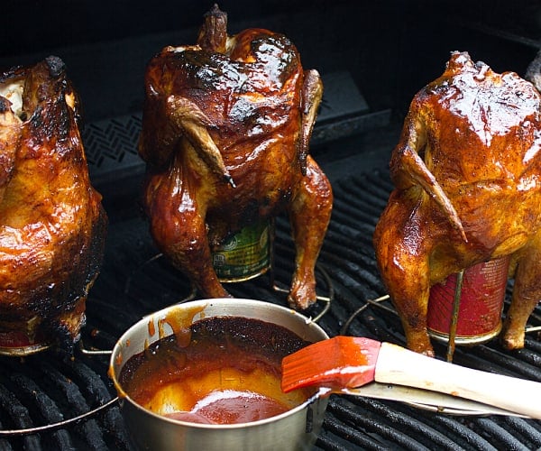 Classic beer can chicken done on the grill. Easy recipe for BBQ chicken. with a rub and sauce