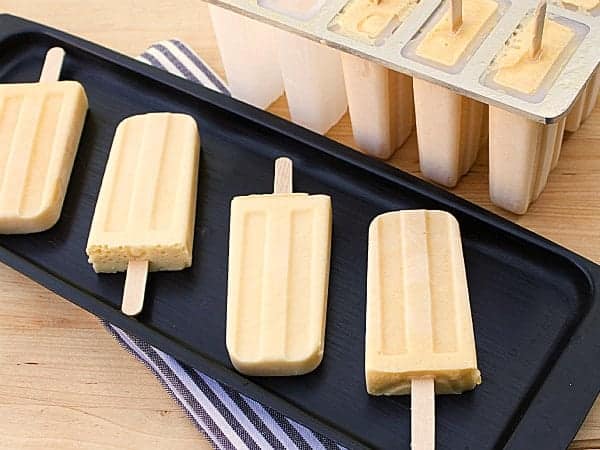 Mango Lassi Popsicle. Frozen Mango smoothie with mango puree, yogurt, milk, honey and cardamom.