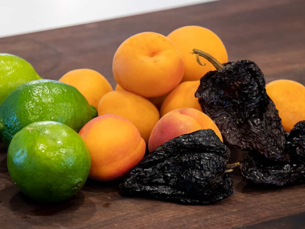 Fresh apricots, limes and dried ancho chilies.