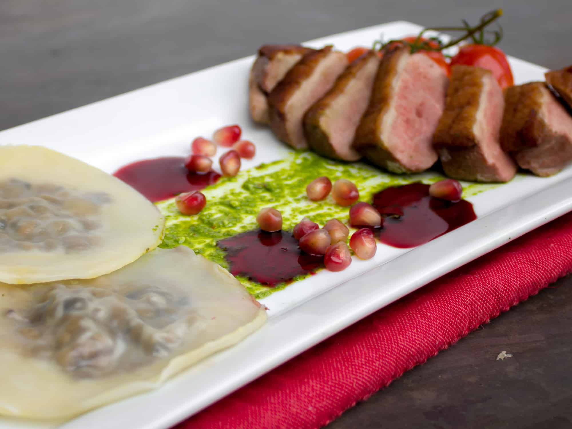 Duck Breast and Cognac Duxelle Wonton Ravioli Recipe with Pomegranate Cognac Sauce and Basil Pesto.