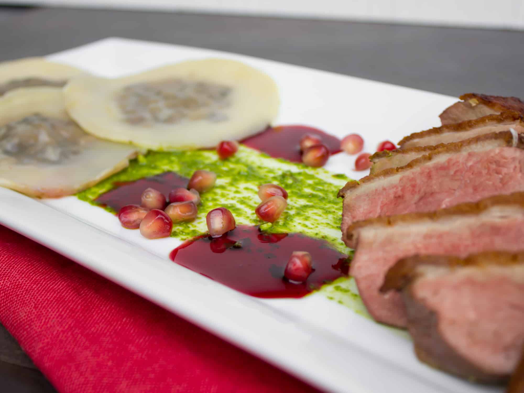 Duck Breast and Cognac Duxelle Wonton Ravioli Recipe with Pomegranate Cognac Sauce and Basil Pesto.