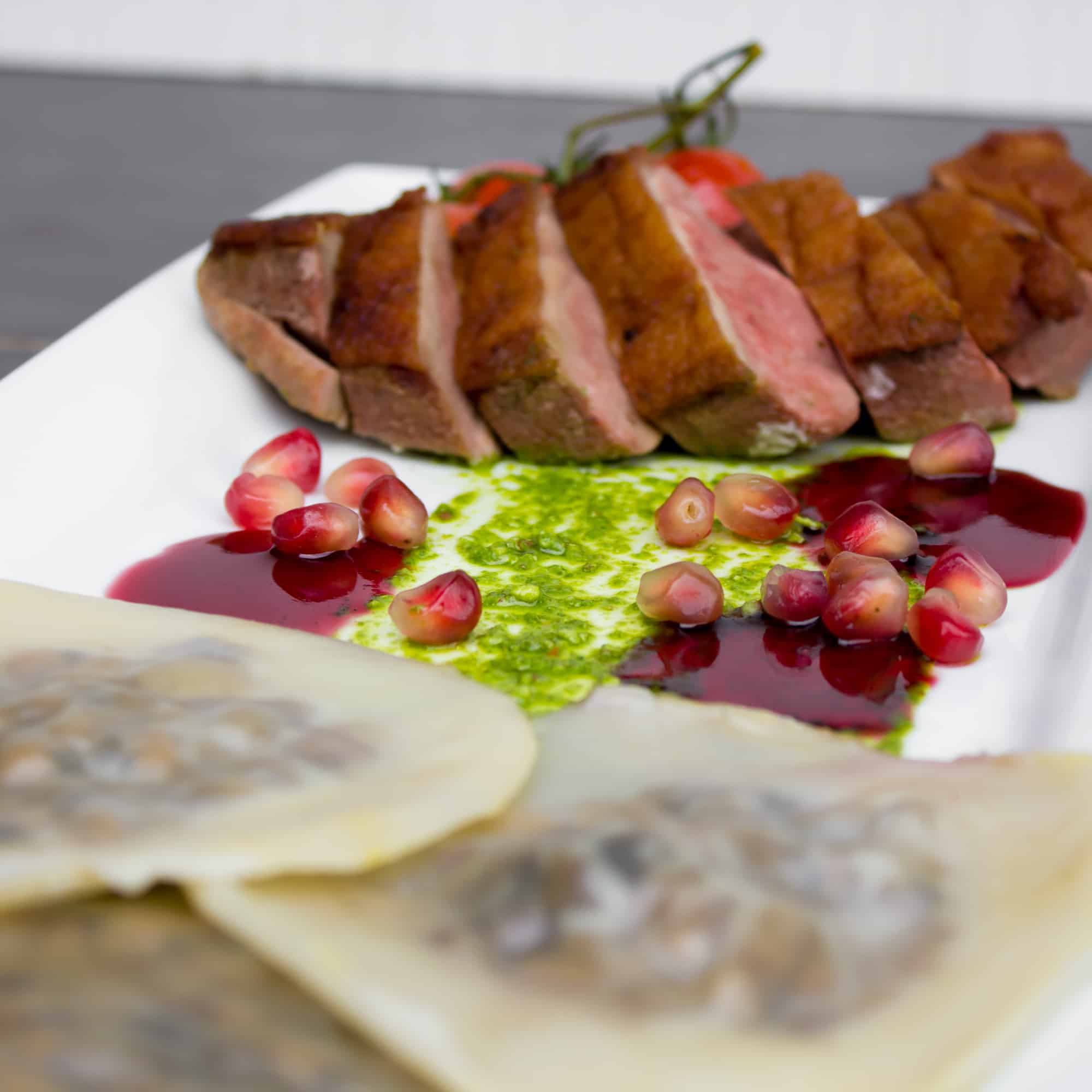 Duck Breast and Cognac Duxelle Wonton Ravioli Recipe with Pomegranate Cognac Sauce and Basil Pesto.