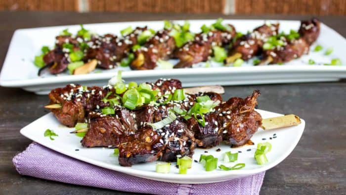 Grilled beef tenderloin skewers marinated in an Asian sesame marinade. Sesame oil, soy sauce, ginger, garlic and green onions.