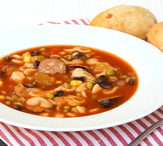 Minestrone soup recipe made with smoked sausage, andouille or kielbasa. Black beans, corn, peas and pasta noodles in the soup with a tomato based broth.