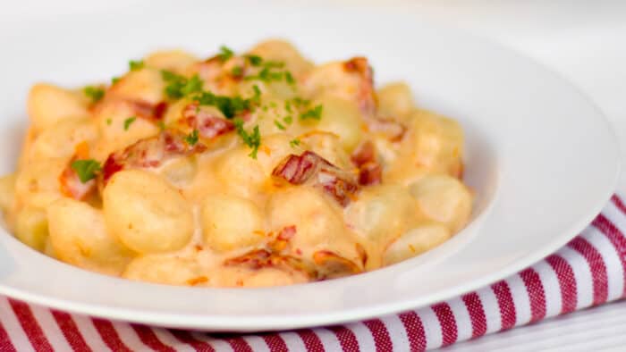 A bowl of gnocchi in a cream sauce.