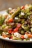 Roasted Brussels sprout salad recipe with bacon, walnuts, feta cheese, green onions, re peppers and a balsamic vinaigrette.