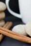 Round cookies piled together and next to cinnamon sticks.