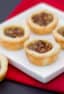 Maple syrup and pecans make up the filling in these mini tarts tassies that are simple and delicious. Cream cheese and butter pastry.
