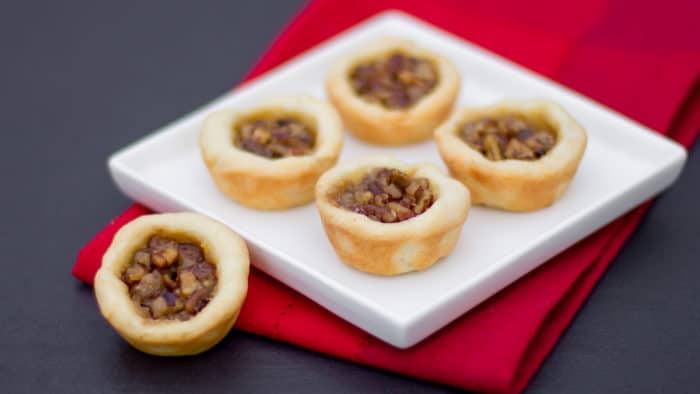 Maple syrup and pecans make up the filling in these mini tarts tassies that are simple and delicious. Cream cheese and butter pastry.