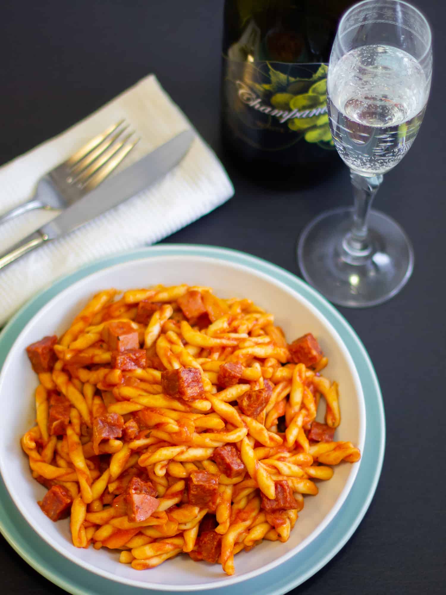 Rustic Italian pasta sauce recipe made with pancetta, mortadella and soppressata salami. Fresh tomatoes, basil, onion and peppers sweeten the sauce. 