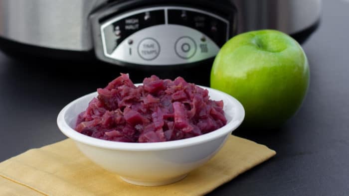 Slow braised red cabbage and apples this German side dish is perfect for the crock pot. Red cabbage, apples, vinegar, onion, sugar. Classic slow cooker recipe.