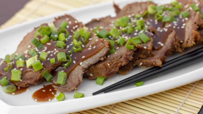 Simple slow cooker recipe for how to cook a beef roast in a crock pot. Boneless ribeye roast with a sweet Asian sesame marinade. Serve on rice with stir fried vegetables.
