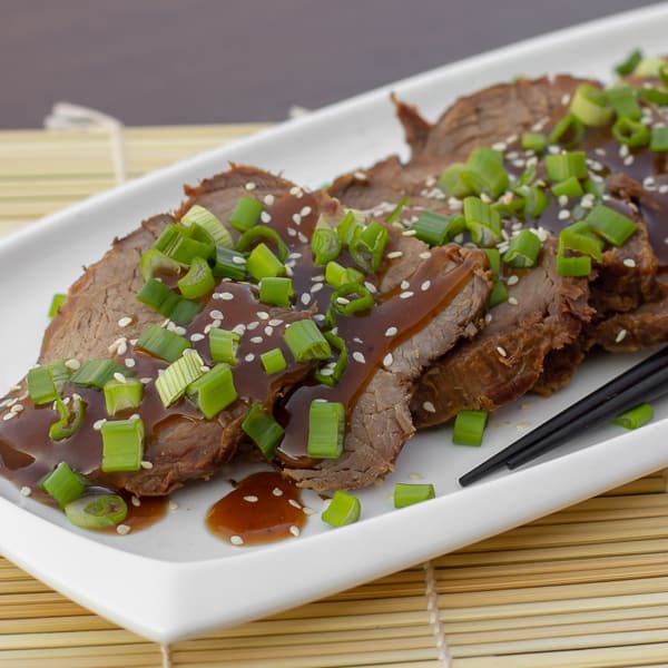 Simple slow cooker recipe for how to cook a beef roast in a crock pot. Boneless ribeye roast with a sweet Asian sesame marinade. Serve on rice with stir fried vegetables.