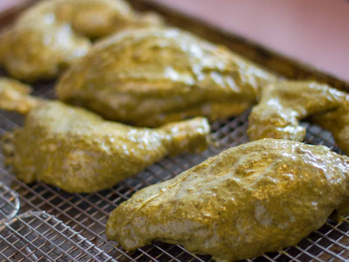 Place the chicken on a baking sheet with a rack to go in the oven.