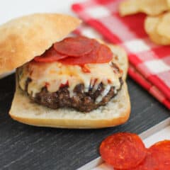 Homemade burger patty with pizza sauce, mozzarella cheese and sliced pepperoni.