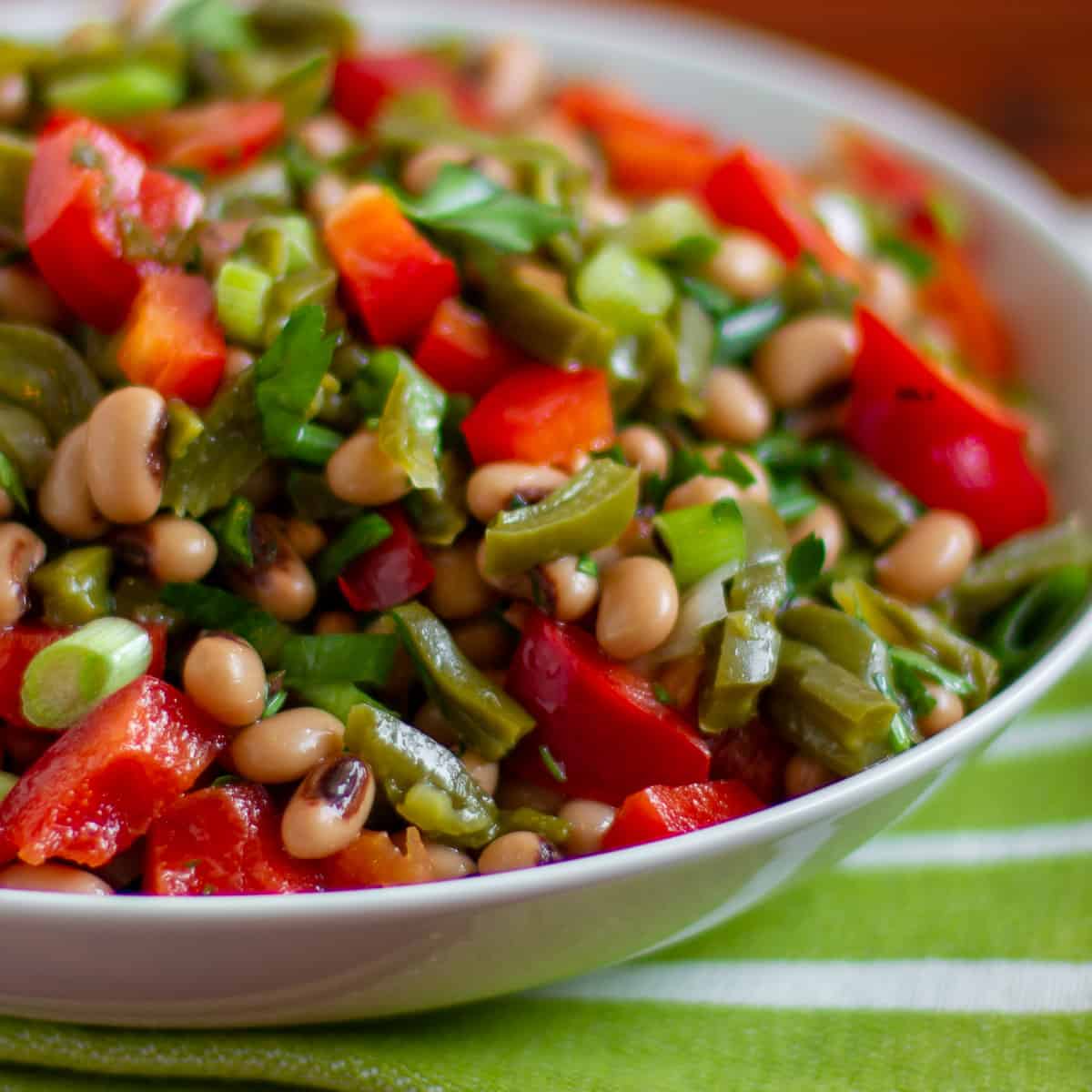 A bowl of Mexican inspired salad with prickly pear cactus and black eyed peas