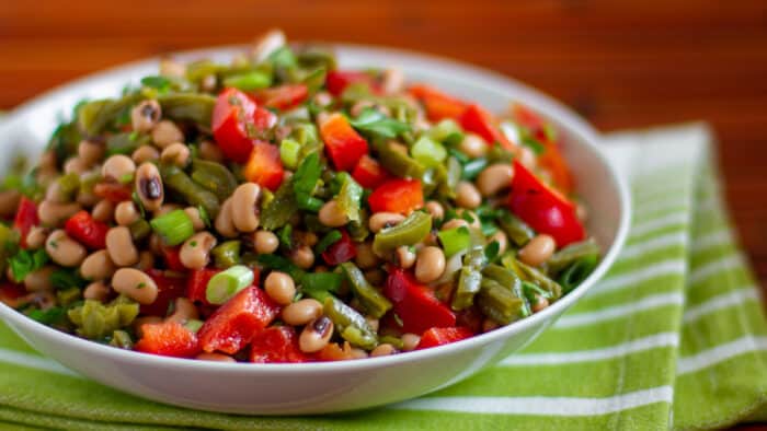 A bowl of Mexican inspired salad with prickly pear cactus and black eyed peas