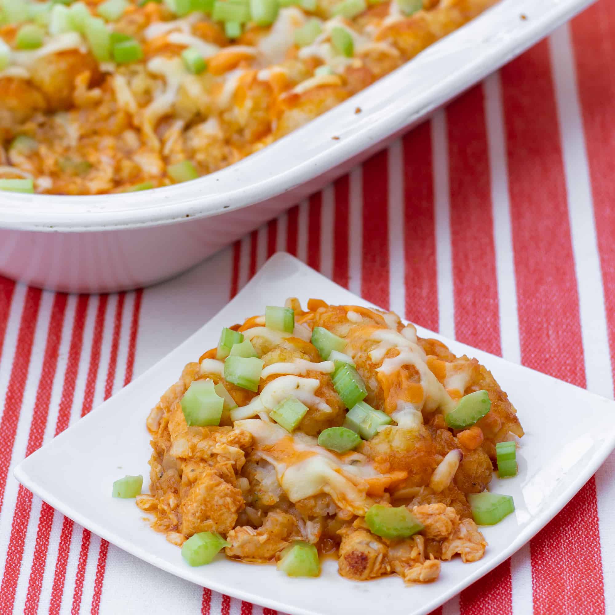 Great pub food and \ comfort food combined. Buffalo chicken with blue cheese covered with Tater Tots and grated cheese. Baked and then topped with celery before serving.