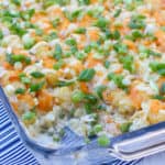 Creamy and cheesy chicken casserole with cream of mushroom soup, sour cream peas and tater tots and grated cheddar. Easy comfort food.