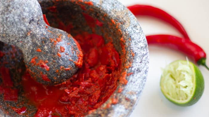 Easy instructions for how to make sambal oelek homemade from scratch using fresh red chili pepers, lime juice and salt.