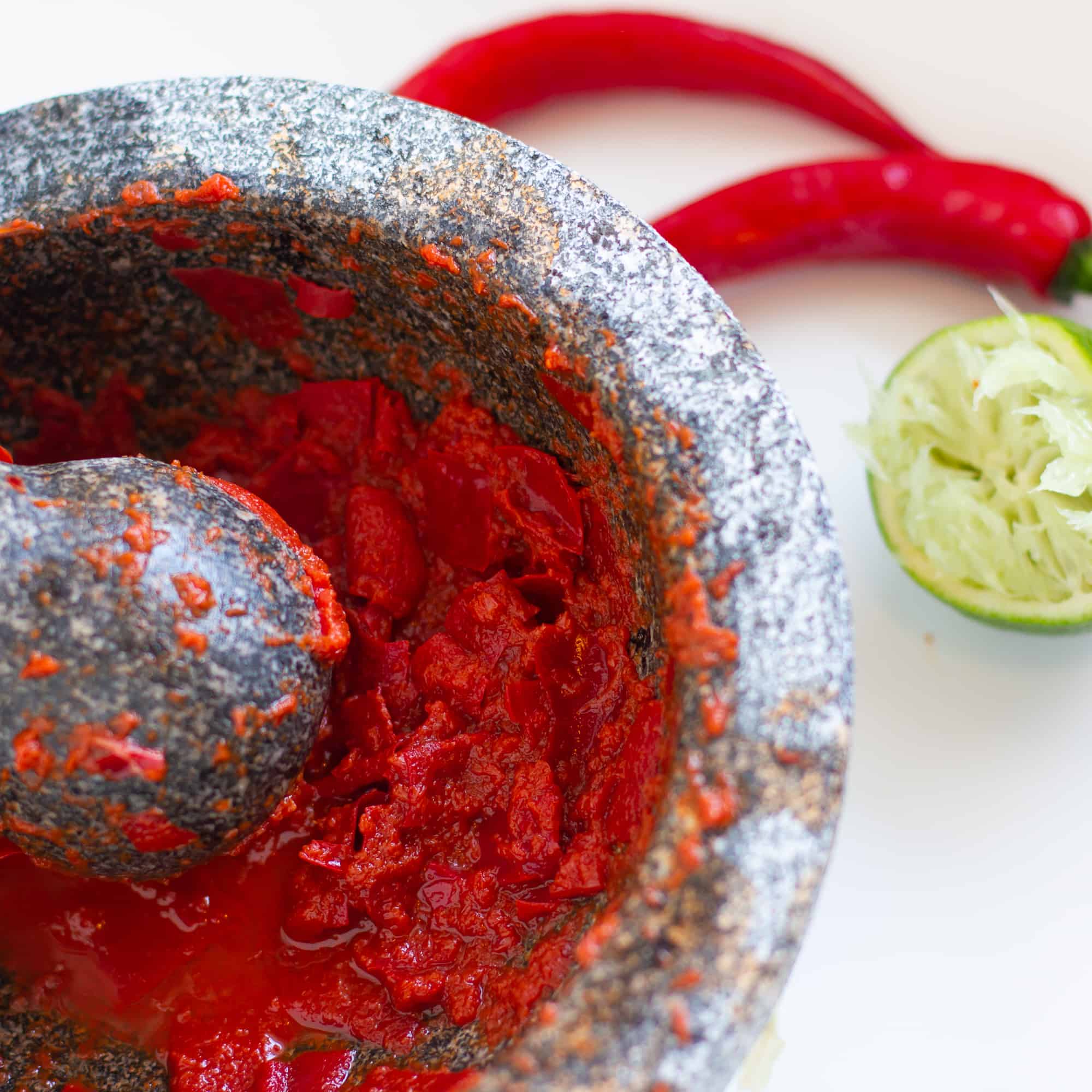 Easy instructions for how to make sambal oelek homemade from scratch using fresh red chili pepers, lime juice and salt.