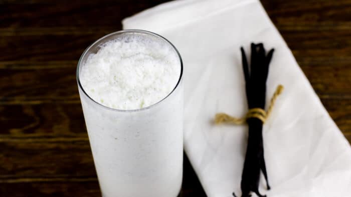 A glass of iced Frappuccino with vanilla beans.