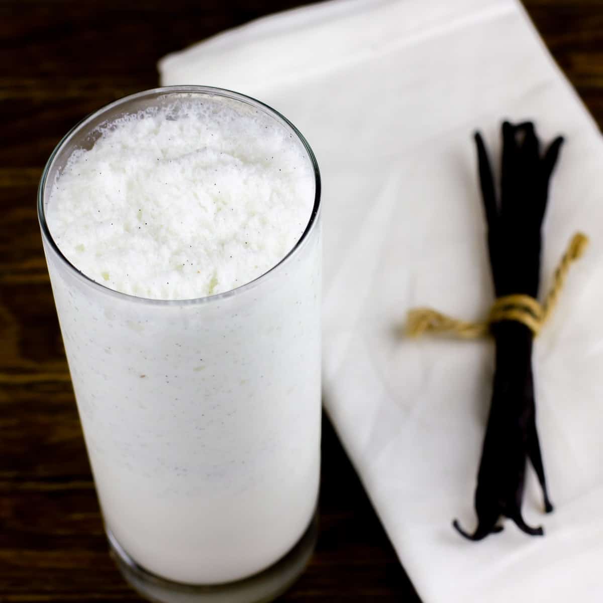 Easy vanilla bean frappe recipe that is just like Starbucks. Iced caffeine free frozen drink with real vanilla beans and cream.