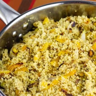 Overhead picture of a saucepan with cooked couscous.