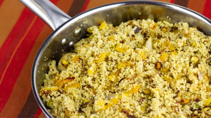 Overhead picture of a saucepan with cooked couscous.