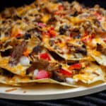 Nachos baked on a round pizza stone