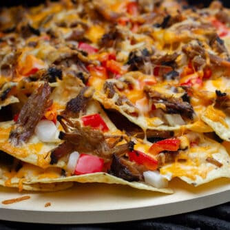 Nachos baked on a round pizza stone