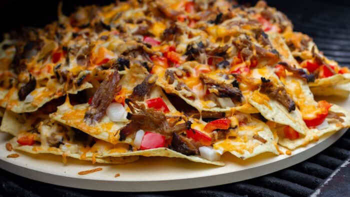 Nachos baked on a round pizza stone