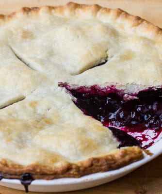 Traditional country pie pastry made with lard and a filling made of fresh blueberries, sugar, tapioca and lemon juice. Flaky, tender and delicious. Easy instructions for how to make this homemade pie.