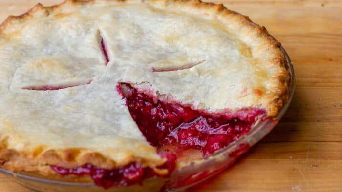 Fresh baked fruit pie with a slice removed