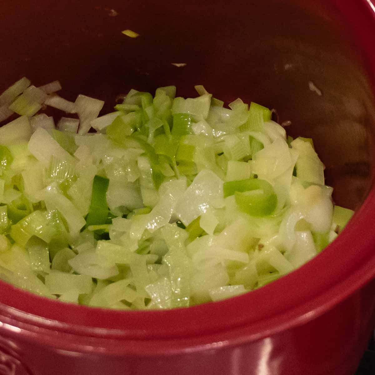 Sauté the onion and leeks in a soup pot until caramelized.
